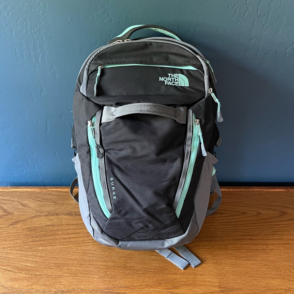 Excellent condition North Face Surge backpack. Padded laptop pocket gray teal